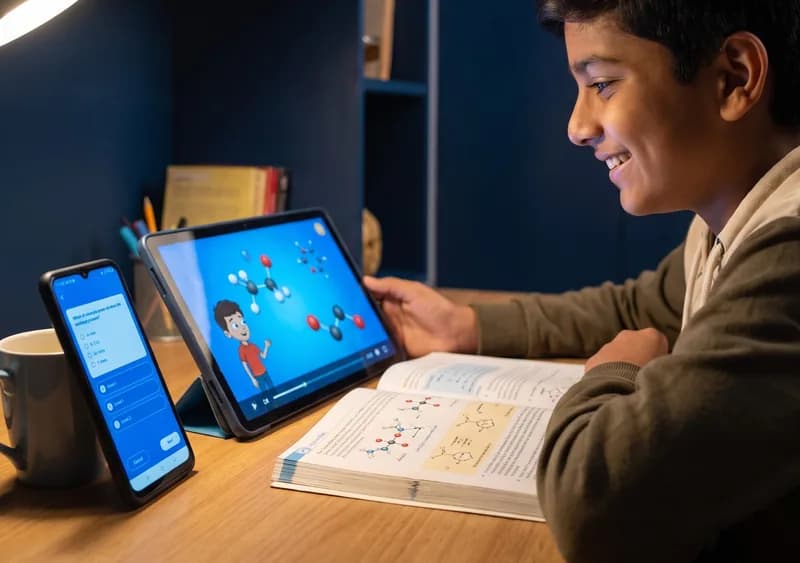 A student learning from an animated lesson, a quiz and a printed textbook